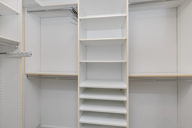 a living room with furniture and floor to ceiling windows