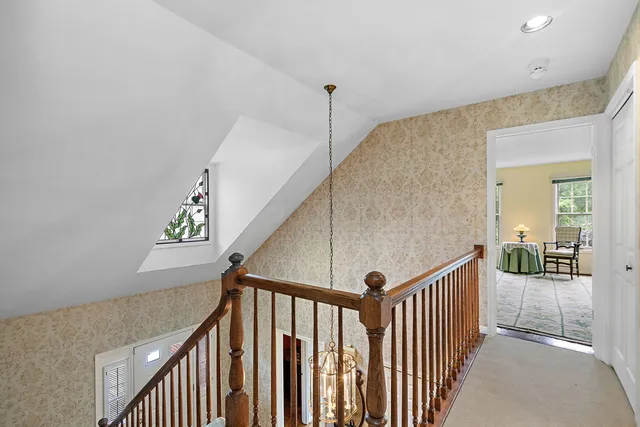 a living room with furniture and a book shelf