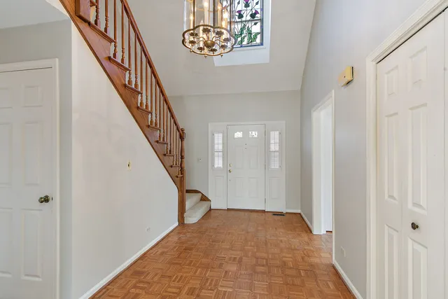 a view of a hallway with wooden floor and entryway
