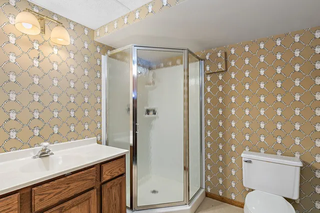 an aerial view of a house with a garden and trees