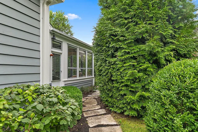 an aerial view of a house with a garden and trees