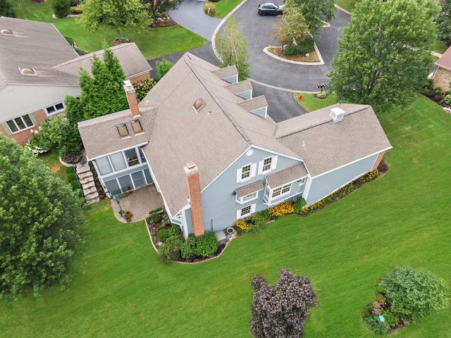 an aerial view of residential houses with outdoor space and lake view
