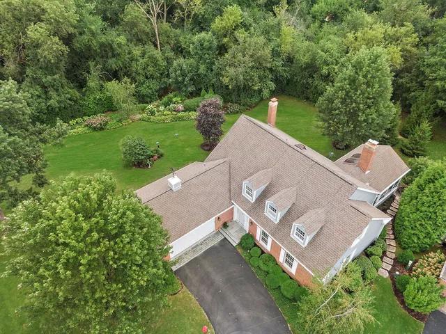 a aerial view of a house with yard and green space