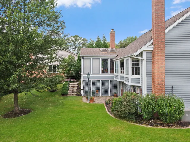a front view of a house with a yard and potted plants