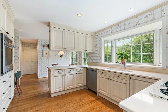 a kitchen with stainless steel appliances cabinets a stove and a sink