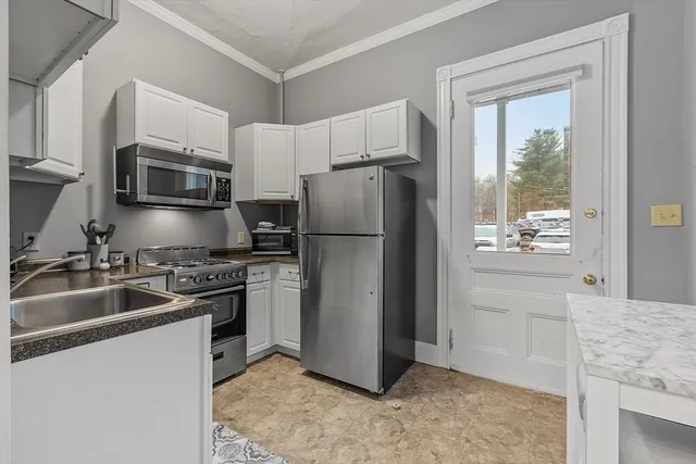 a kitchen with a refrigerator stove and microwave
