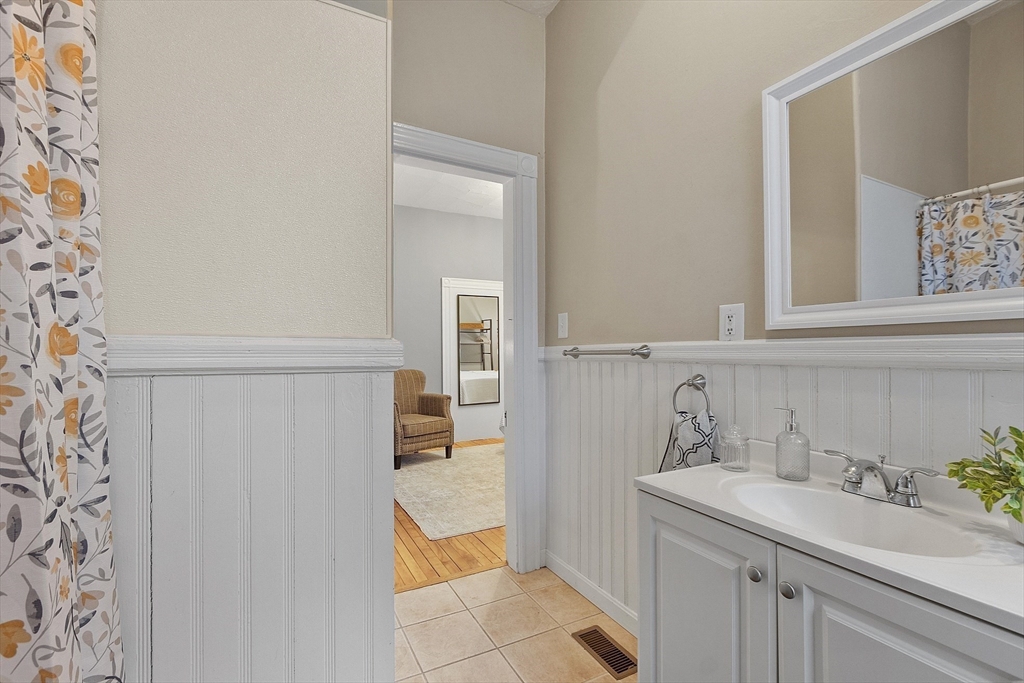 113 Main Street, Unit 3 Pepperell, MA 01463 - Photo 9 of 10 a bathroom with a sink and a mirror