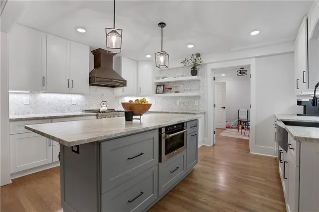 a kitchen with a sink a stove and chairs