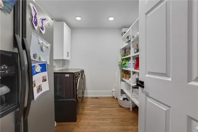 a kitchen with stainless steel appliances granite countertop a refrigerator and a sink