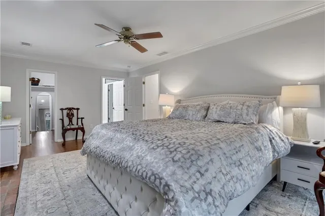 a bedroom with a bed and ceiling fan