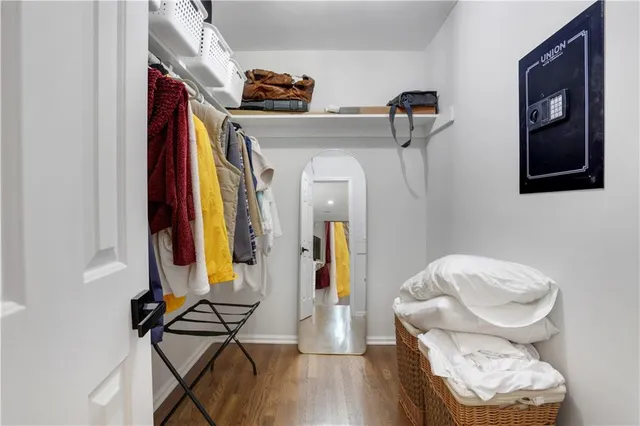 a view of walk in closet with clothes and shoes