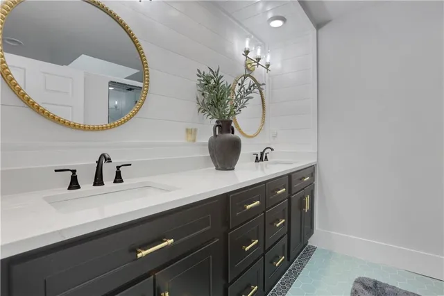 a bathroom with a double vanity sink and a mirror
