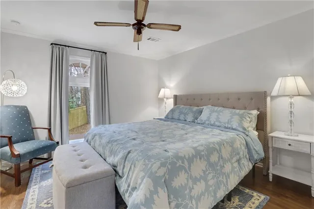 a spacious bedroom with a bed and a lamp