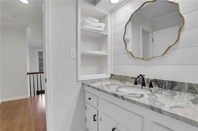 a bathroom with a granite countertop sink and a mirror