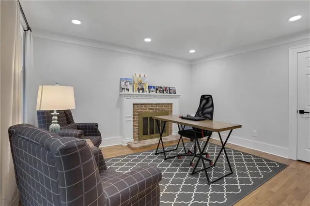 a living room with furniture a rug and a table