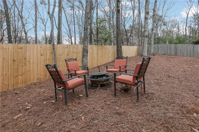 a couple of chairs sitting in backyard of house