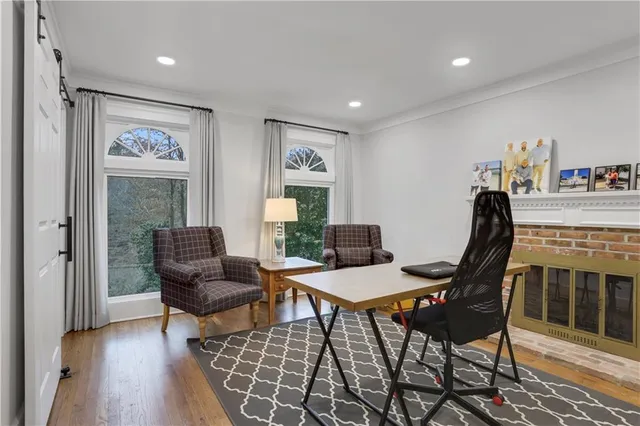 a workspace room with furniture wooden floor and a rug