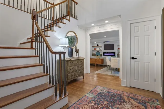 a view of entryway and hall with wooden floor