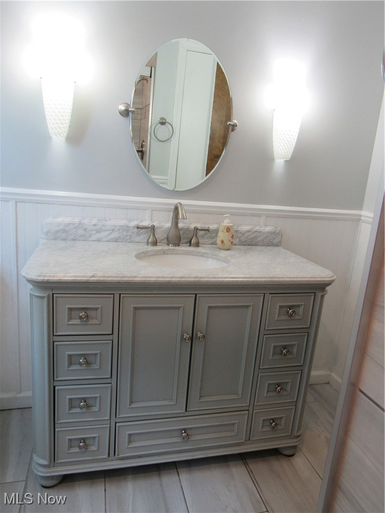 1120 Vincent Road Southeast North Canton, OH 44720 - Photo 31 of 50 Main Bathroom featuring tile floors, chair rail, wainscot and vanity