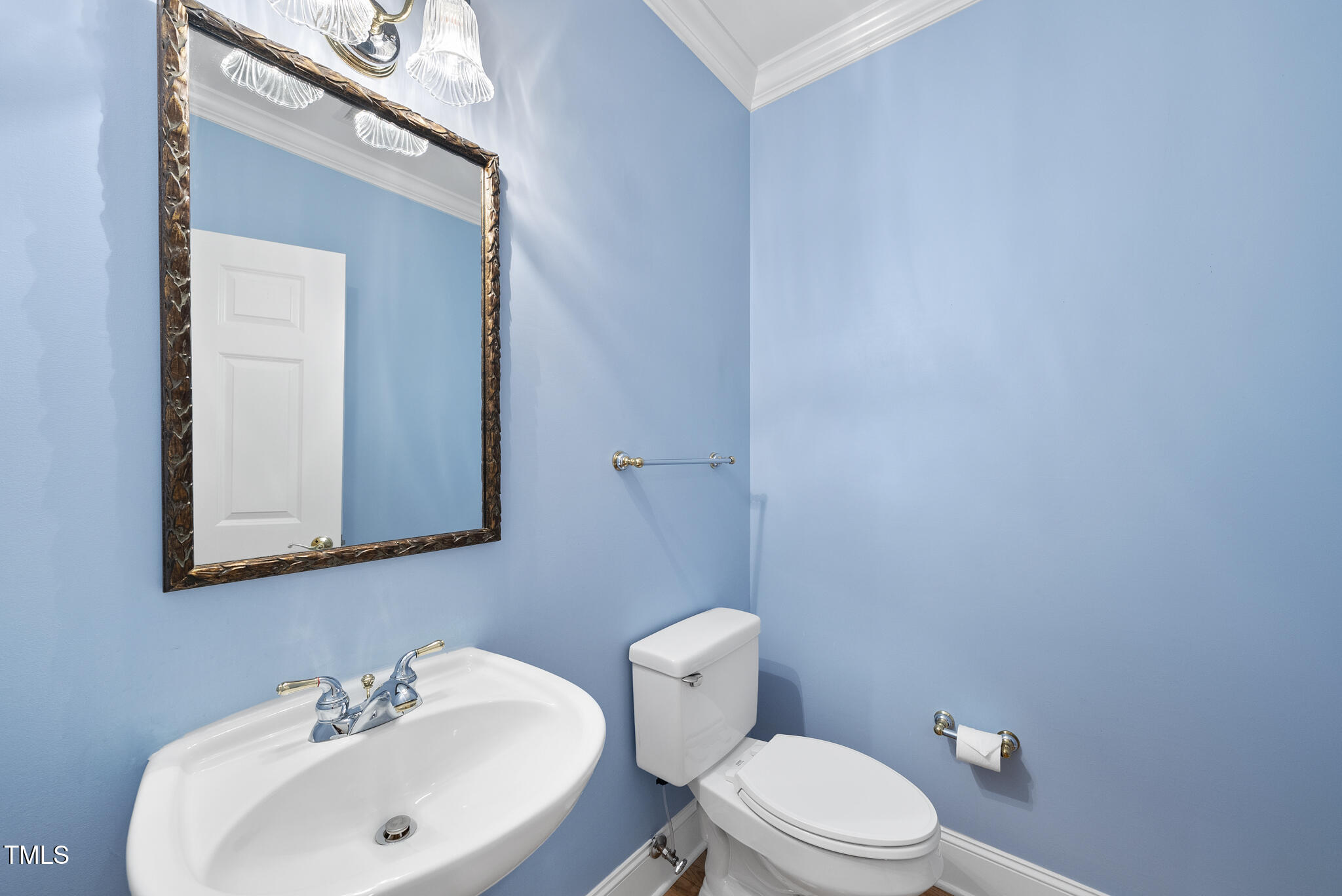 3700 Baron Cooper Pass, Unit 302 Raleigh, NC 27612 - Photo 20 of 67 a bathroom with a sink a mirror and a toilet