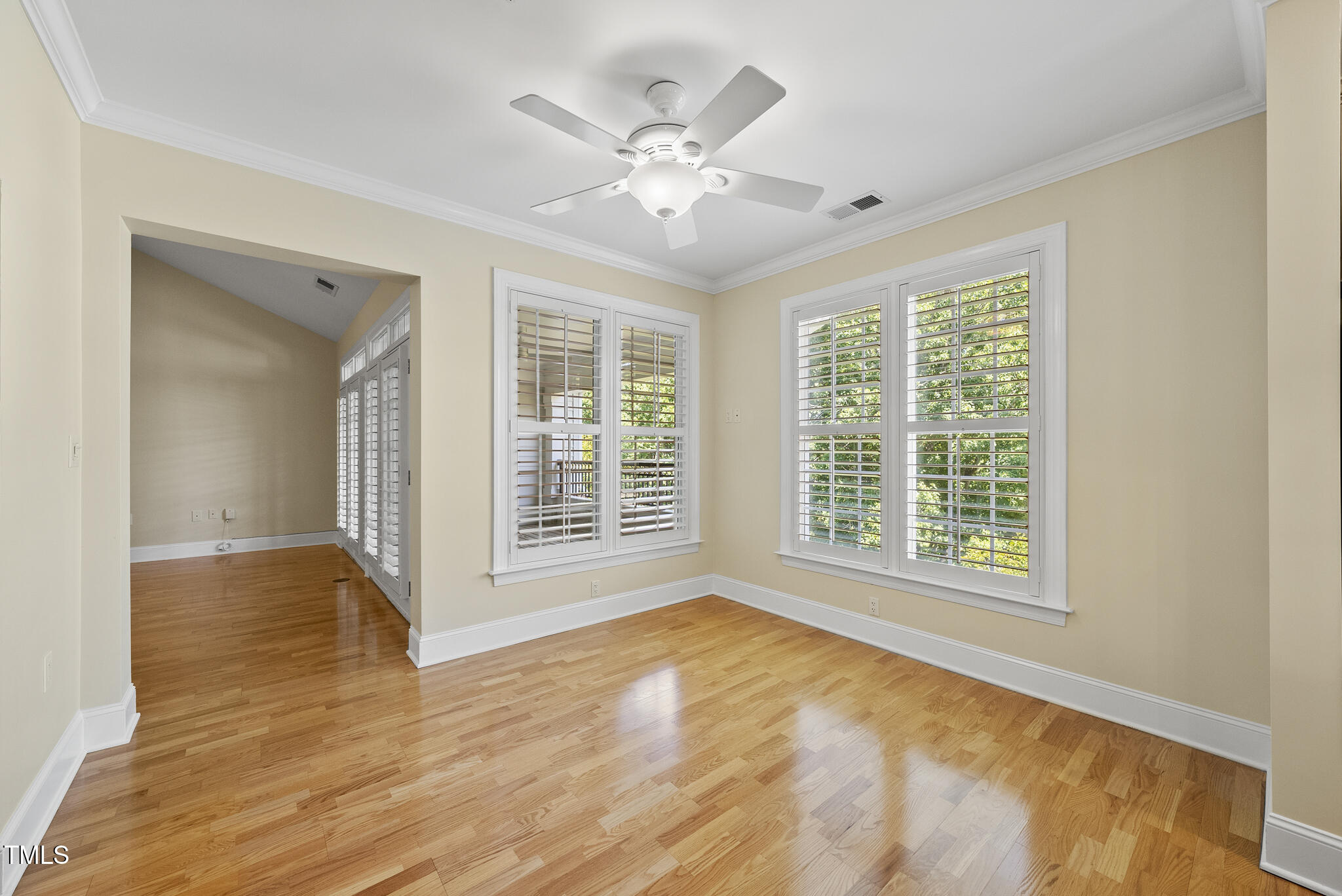 3700 Baron Cooper Pass, Unit 302 Raleigh, NC 27612 - Photo 23 of 67 a view of an empty room with wooden floor and a window