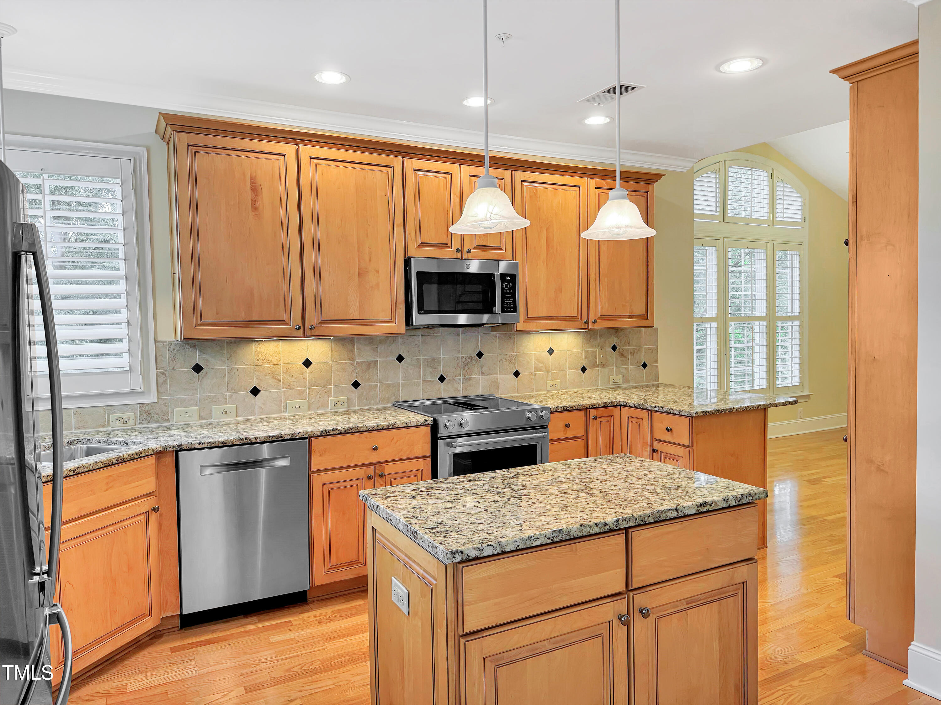 3700 Baron Cooper Pass, Unit 302 Raleigh, NC 27612 - Photo 25 of 67 a kitchen with stainless steel appliances granite countertop a stove a sink and a microwave