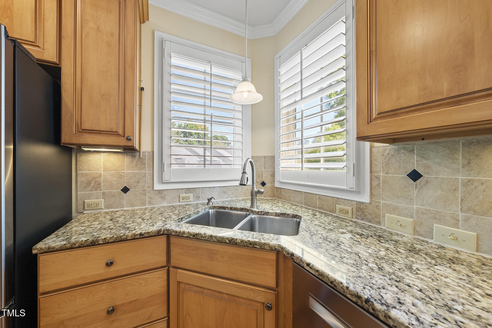 3700 Baron Cooper Pass, Unit 302 Raleigh, NC 27612 - Photo 28 of 67 a kitchen with granite countertop sink and cabinets
