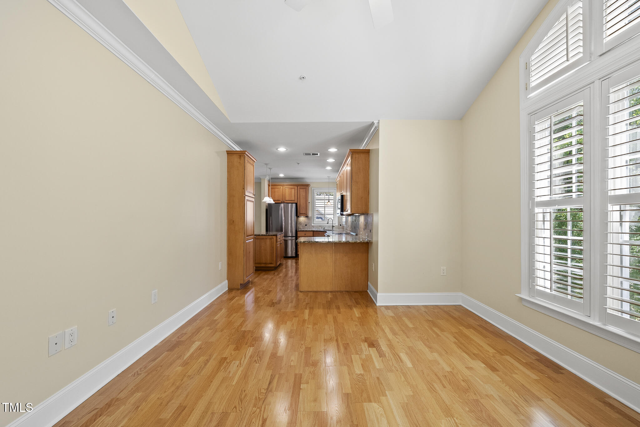3700 Baron Cooper Pass, Unit 302 Raleigh, NC 27612 - Photo 32 of 67 a view of a kitchen with kitchen island wooden floor center island and stainless steel appliances
