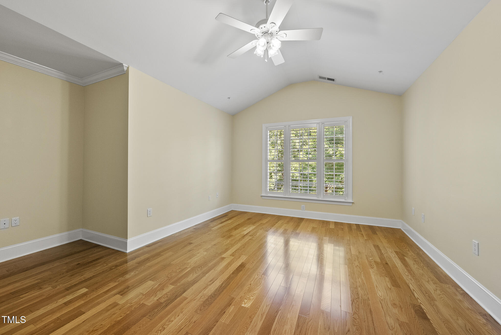 3700 Baron Cooper Pass, Unit 302 Raleigh, NC 27612 - Photo 35 of 67 an empty room with wooden floor chandelier fan and windows