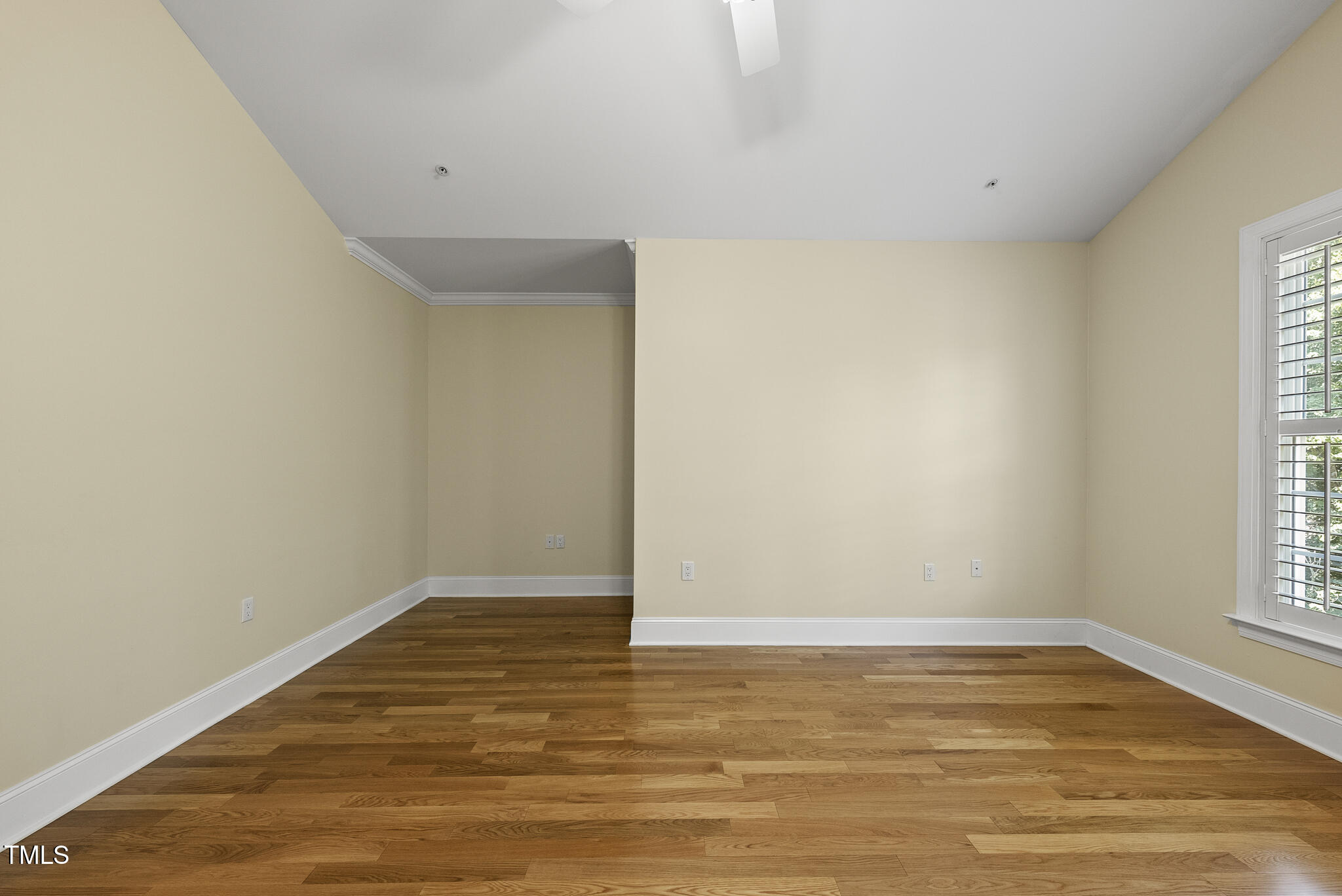 3700 Baron Cooper Pass, Unit 302 Raleigh, NC 27612 - Photo 37 of 67 a view of an empty room with wooden floor and a window
