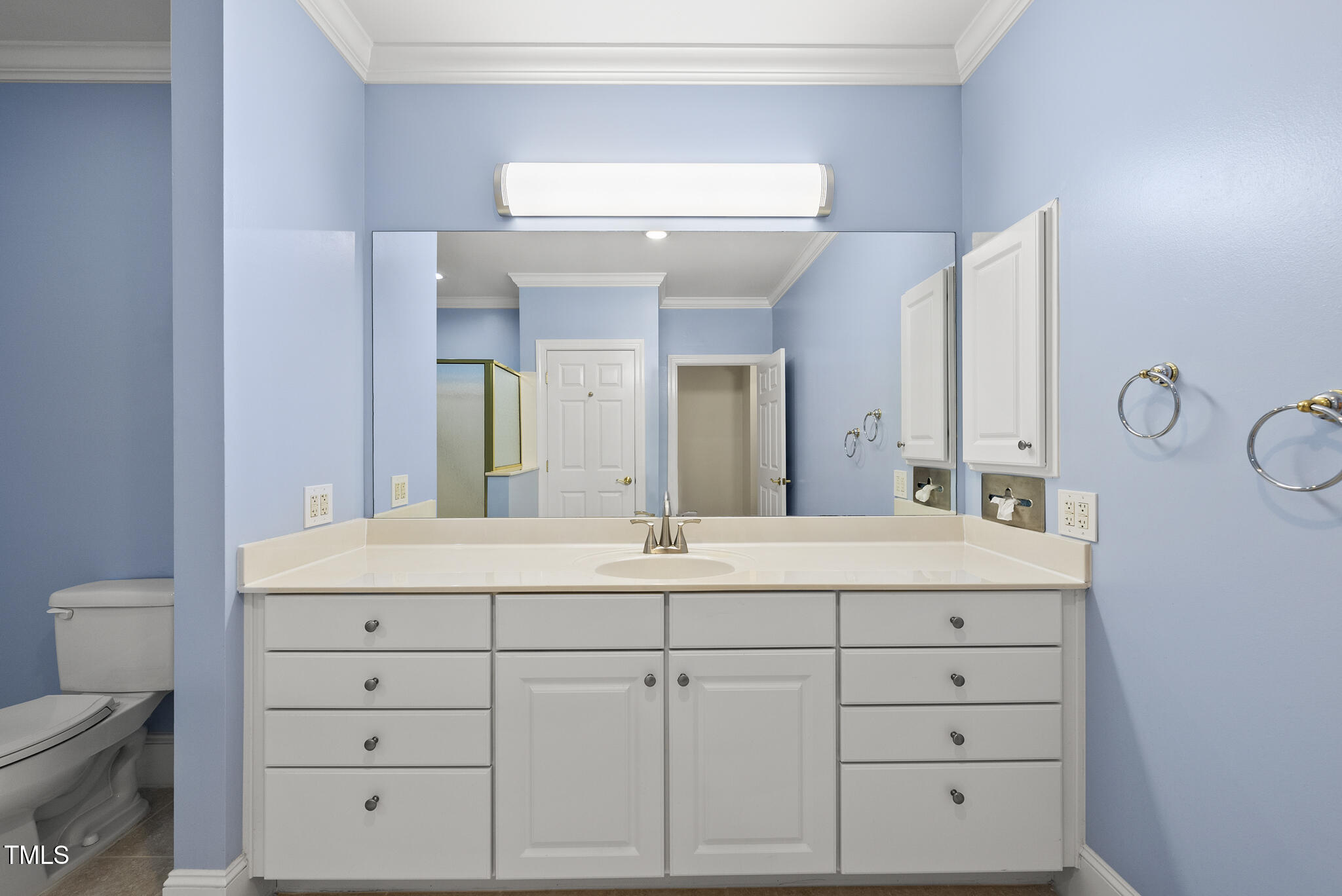 3700 Baron Cooper Pass, Unit 302 Raleigh, NC 27612 - Photo 38 of 67 a bathroom with a sink and a mirror