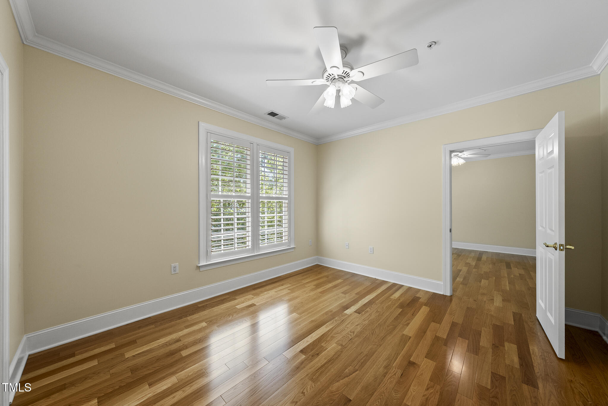 3700 Baron Cooper Pass, Unit 302 Raleigh, NC 27612 - Photo 42 of 67 a view of an empty room with wooden floor and a window