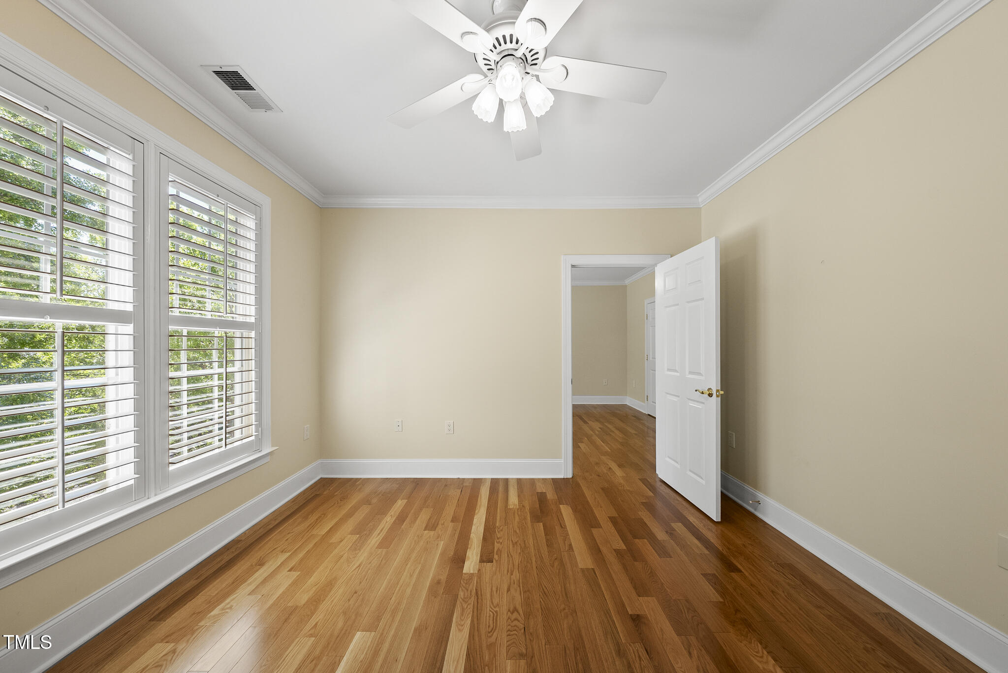 3700 Baron Cooper Pass, Unit 302 Raleigh, NC 27612 - Photo 43 of 67 a view of empty room with wooden floor and fan