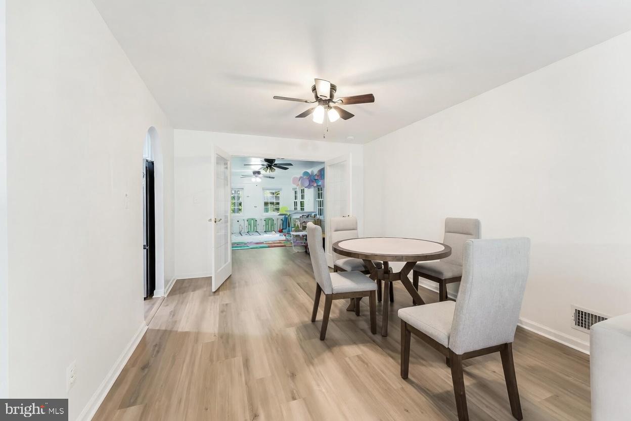 11621 Sourwood Lane Reston, VA 20191 - Photo 20 of 26 a view of a dining room with furniture and wooden floor