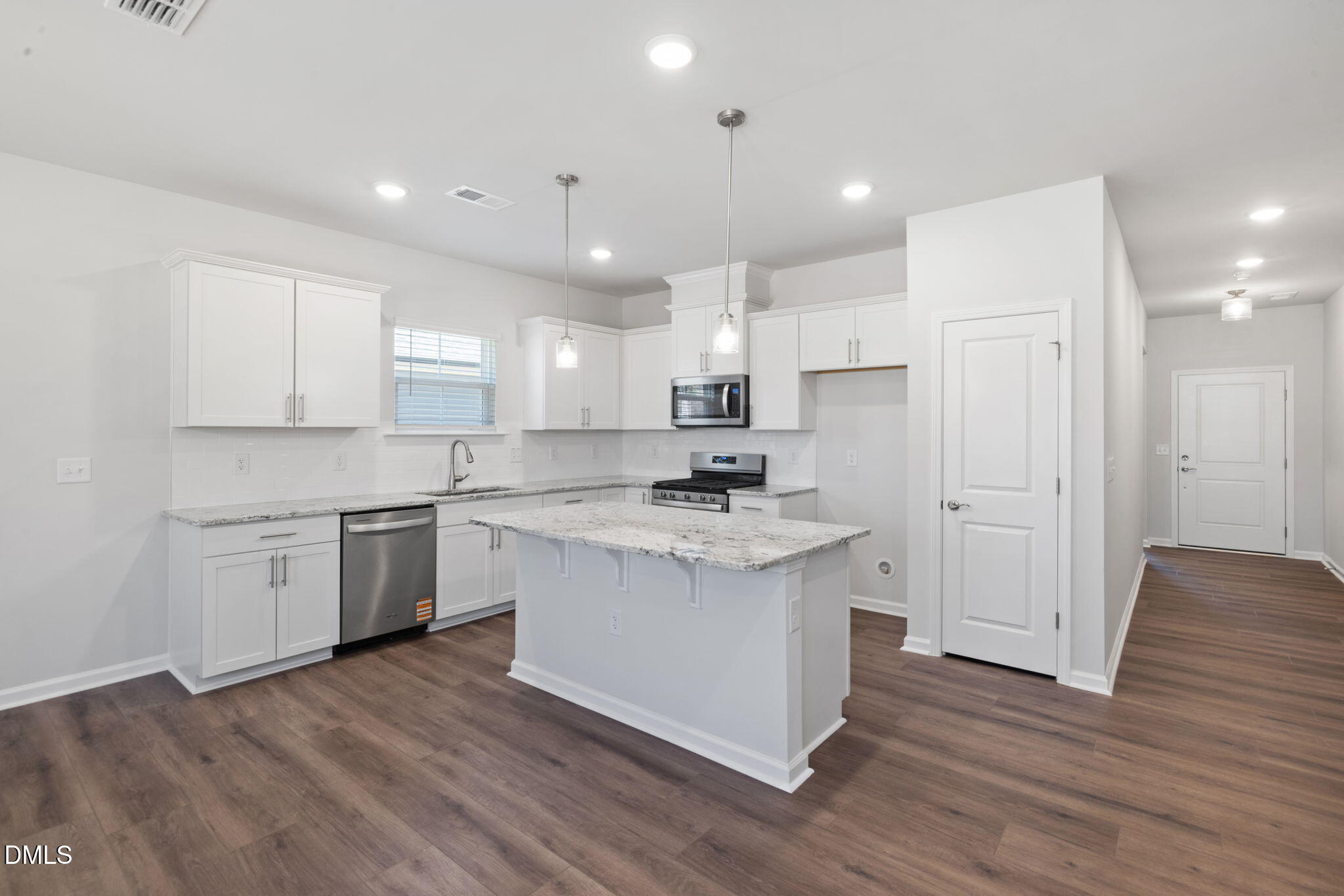 332 Broomside Avenue Raleigh, NC 27603 - Photo 4 of 32 a kitchen with a white wooden cabinets and white stainless steel appliances