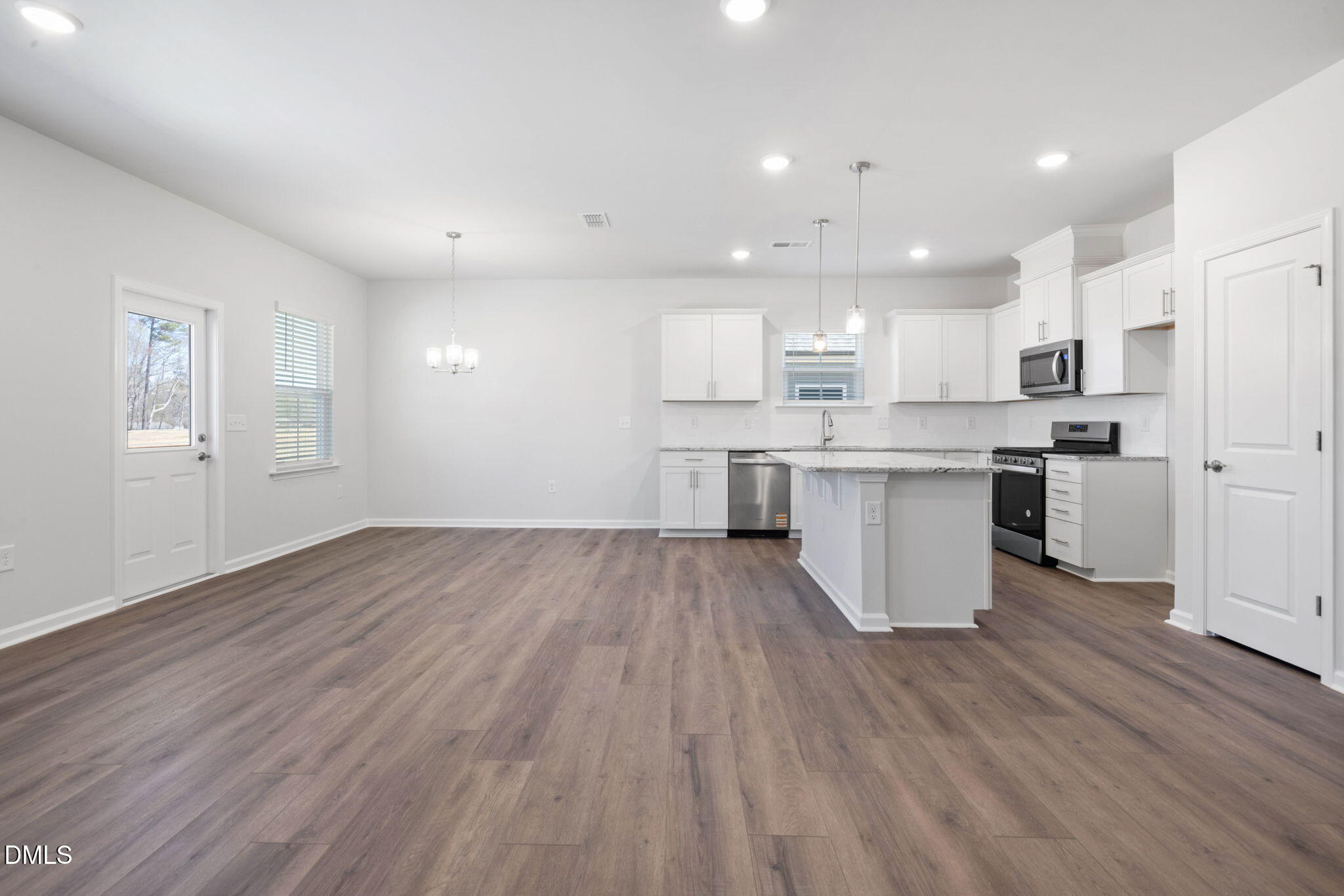 332 Broomside Avenue Raleigh, NC 27603 - Photo 9 of 32 a kitchen with wooden floors and white cabinets