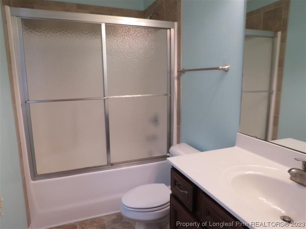 44 Archer Drive Bunnlevel, NC 28323 - Photo 9 of 10 a bathroom with a granite countertop sink toilet and shower