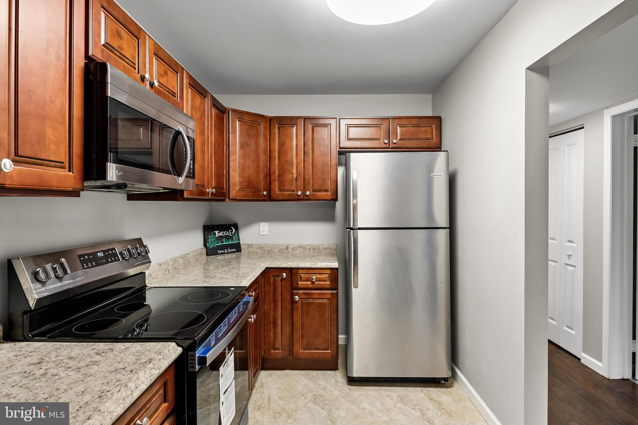 25 South Church Road, Unit 129 Maple Shade, NJ 08052 - Photo 11 of 24 a kitchen with stainless steel appliances granite countertop a granite counter tops and a refrigerator
