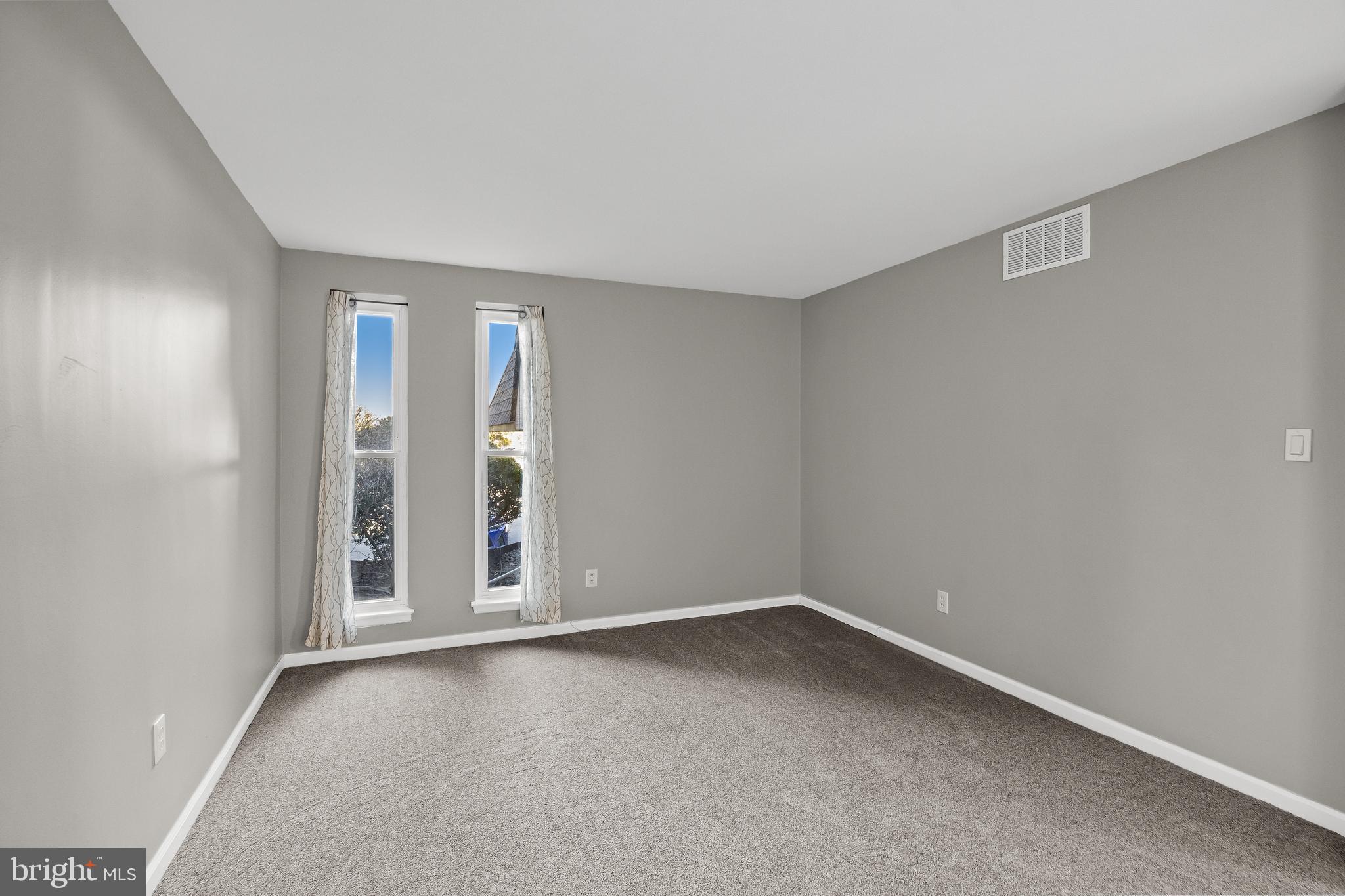 25 South Church Road, Unit 129 Maple Shade, NJ 08052 - Photo 19 of 24 an empty room with entrance and windows