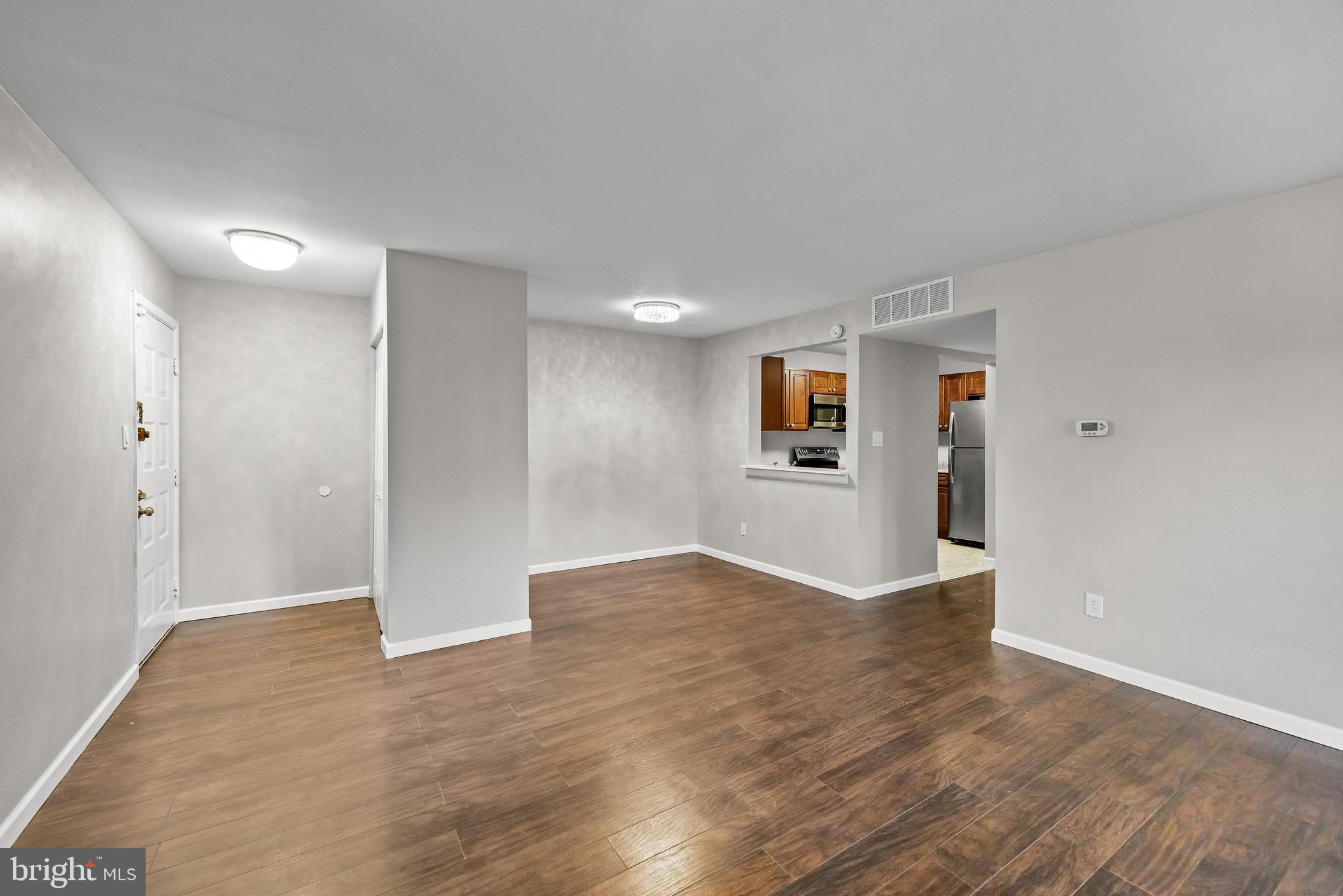 25 South Church Road, Unit 129 Maple Shade, NJ 08052 - Photo 7 of 24 a view of an empty room with wooden floor and windows