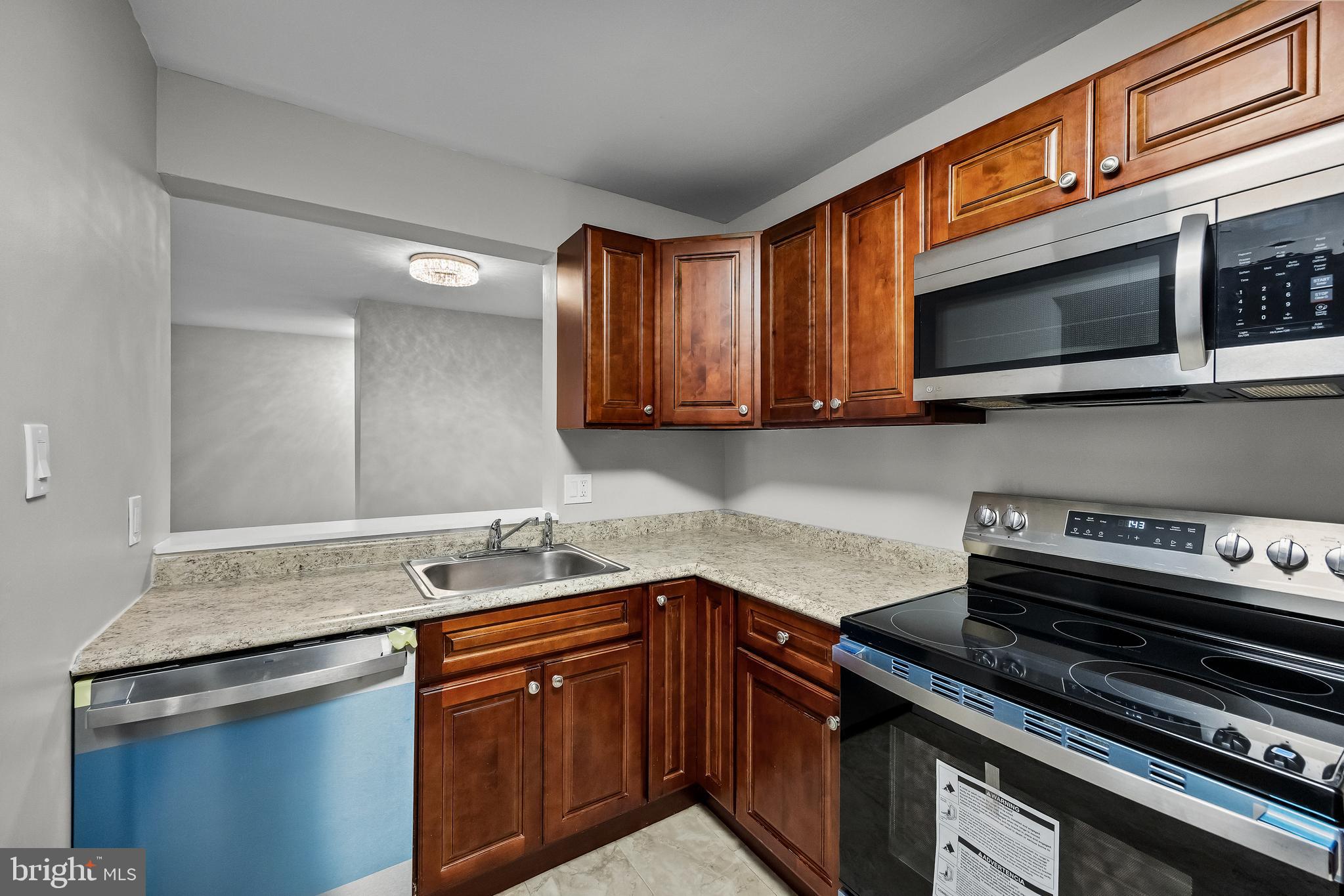 25 South Church Road, Unit 129 Maple Shade, NJ 08052 - Photo 10 of 24 a kitchen with stainless steel appliances granite countertop a sink and a stove
