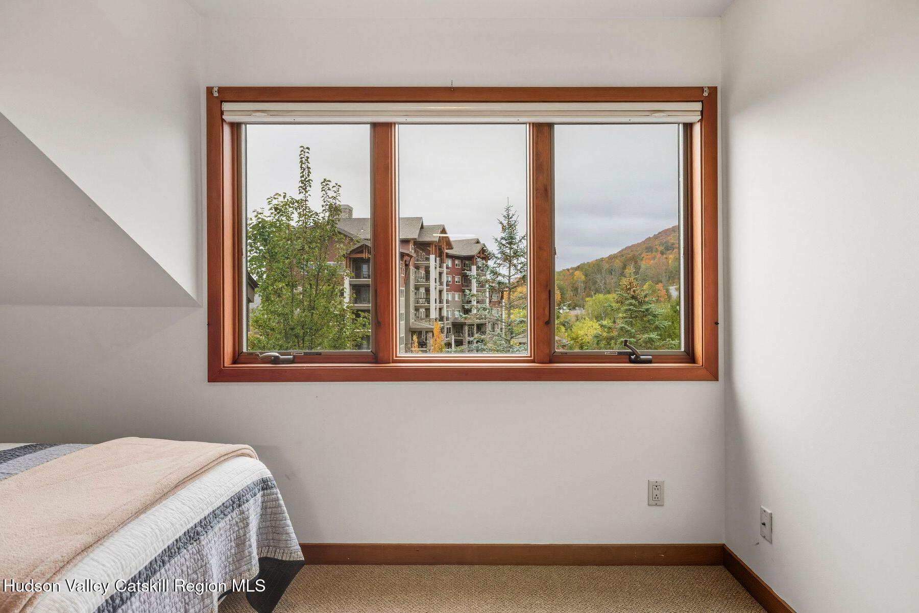 3 The Enclave Windham, NY 12496 - Photo 15 of 59 a bedroom with a bed and a window