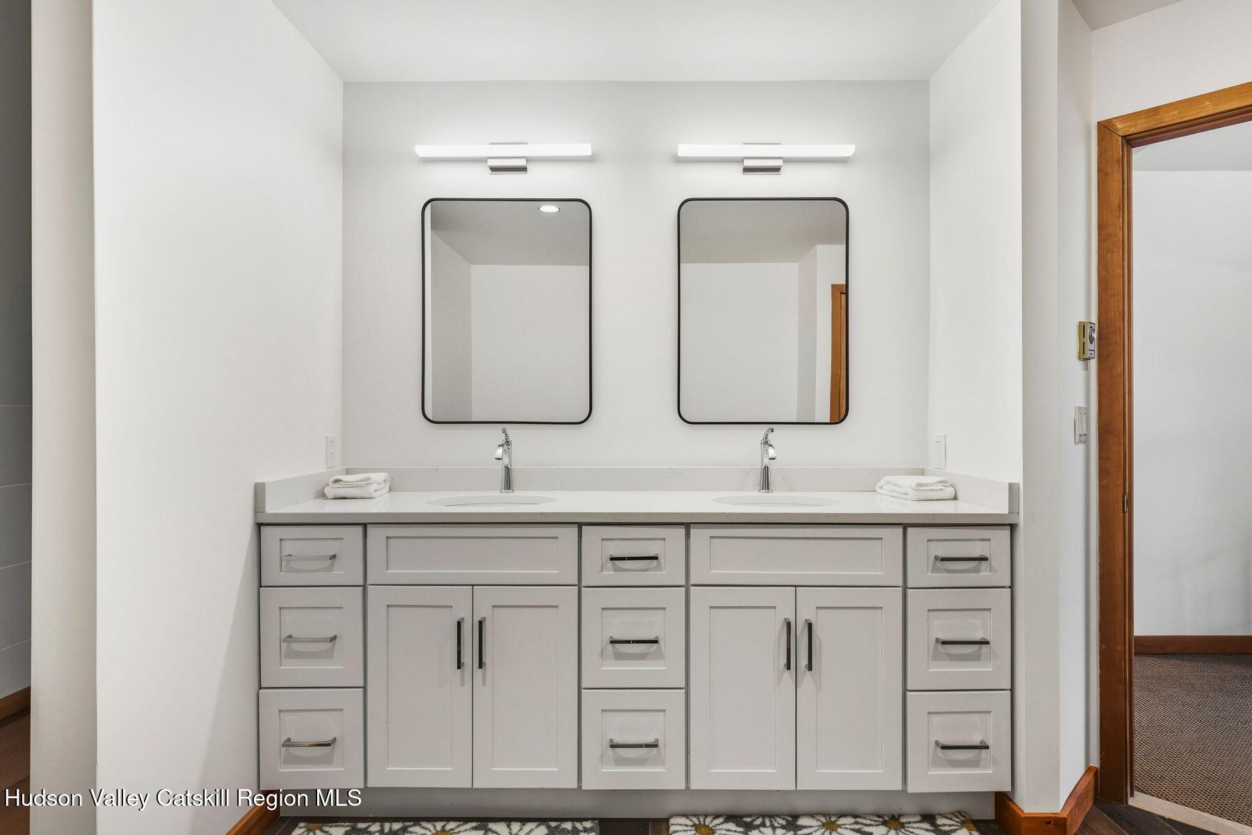 3 The Enclave Windham, NY 12496 - Photo 16 of 59 a bathroom with double sink and a mirror