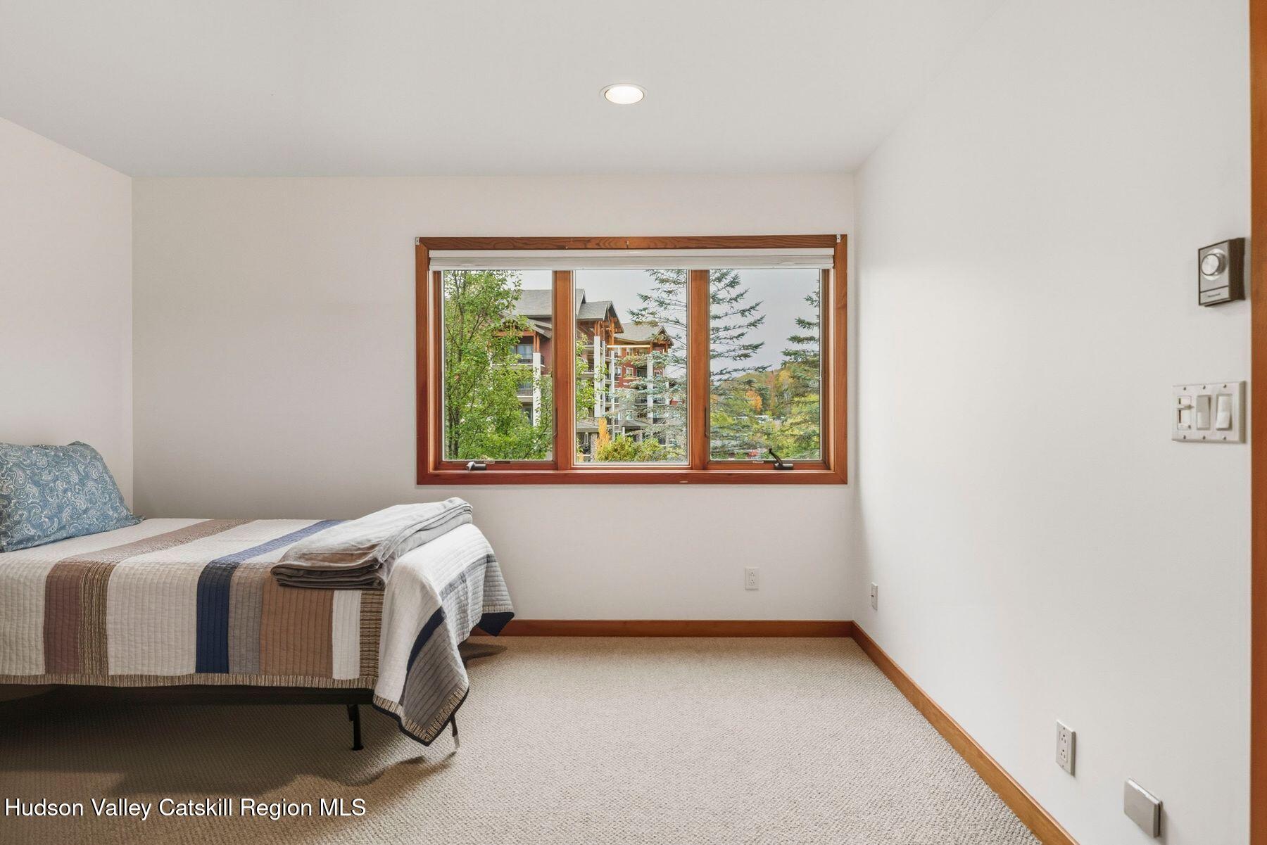 3 The Enclave Windham, NY 12496 - Photo 21 of 59 a bedroom with a bed and a window