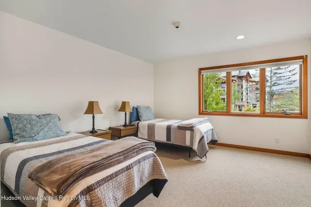 a spacious bedroom with a bed and window