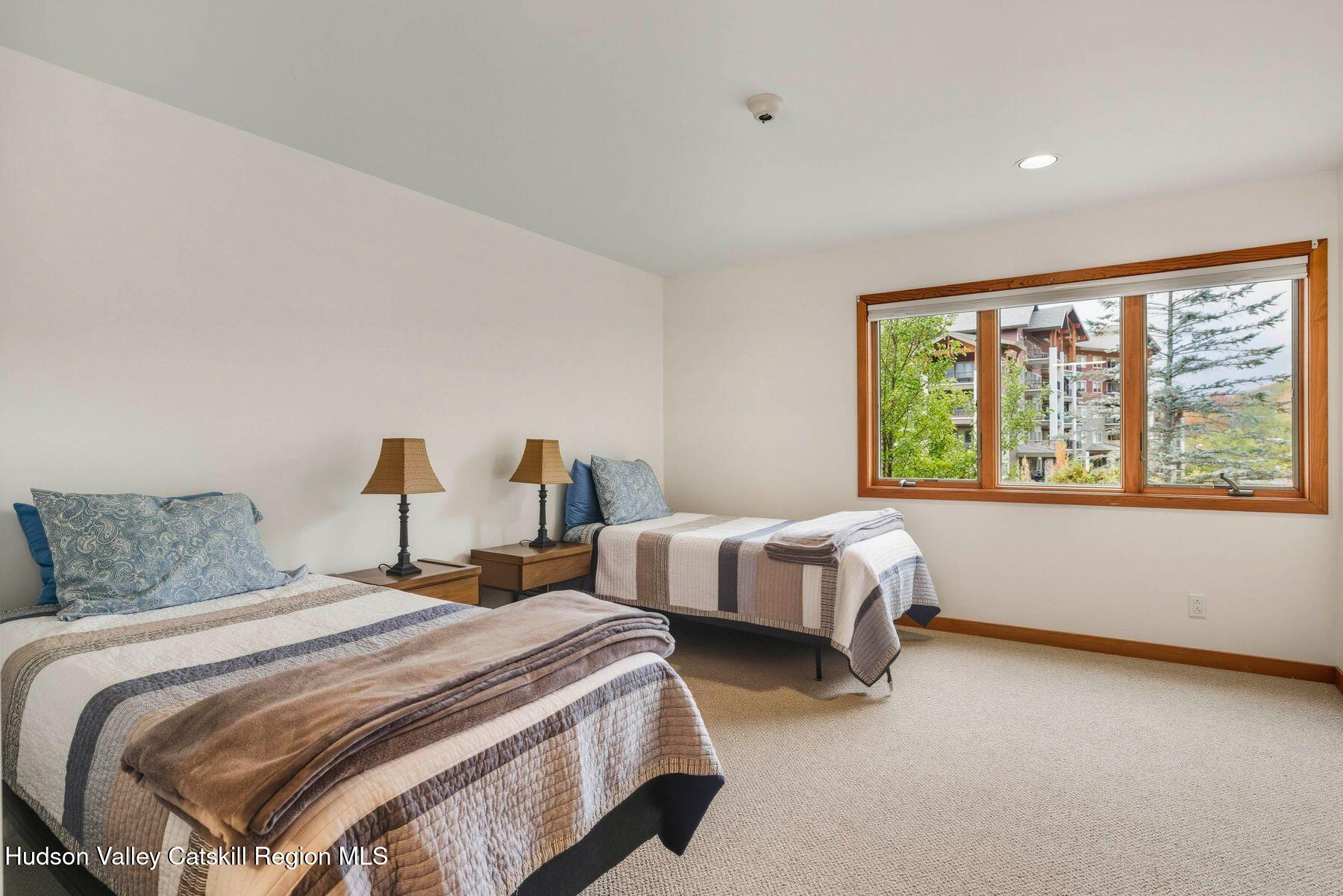3 The Enclave Windham, NY 12496 - Photo 22 of 59 a bedroom with two beds and a large window
