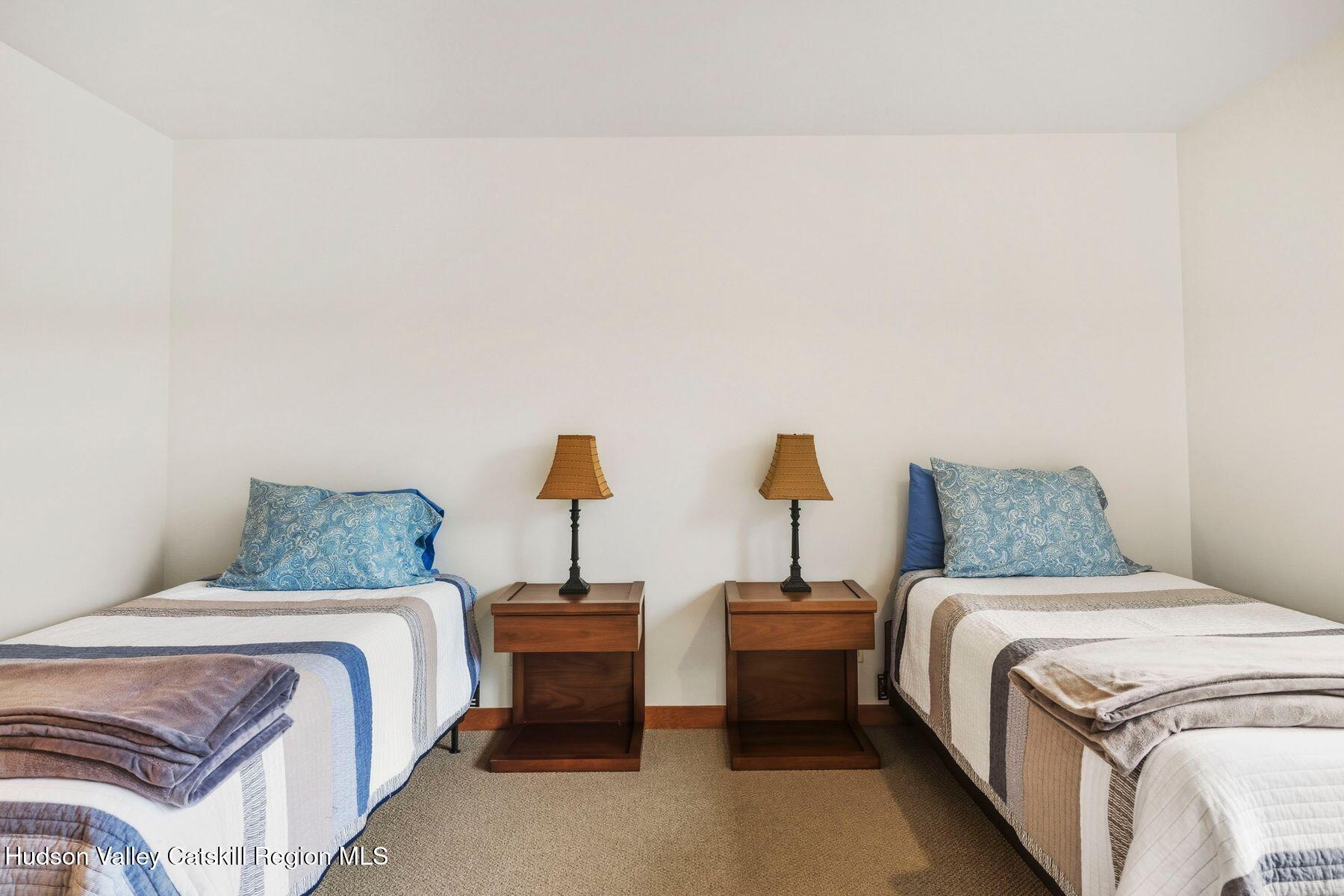 3 The Enclave Windham, NY 12496 - Photo 23 of 59 a bedroom with a bed and lamp