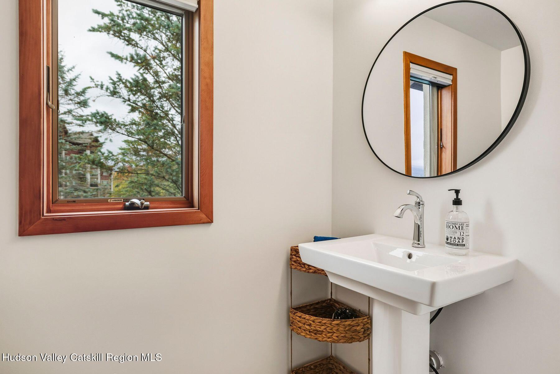 3 The Enclave Windham, NY 12496 - Photo 29 of 59 a bathroom with a sink a mirror and a toilet