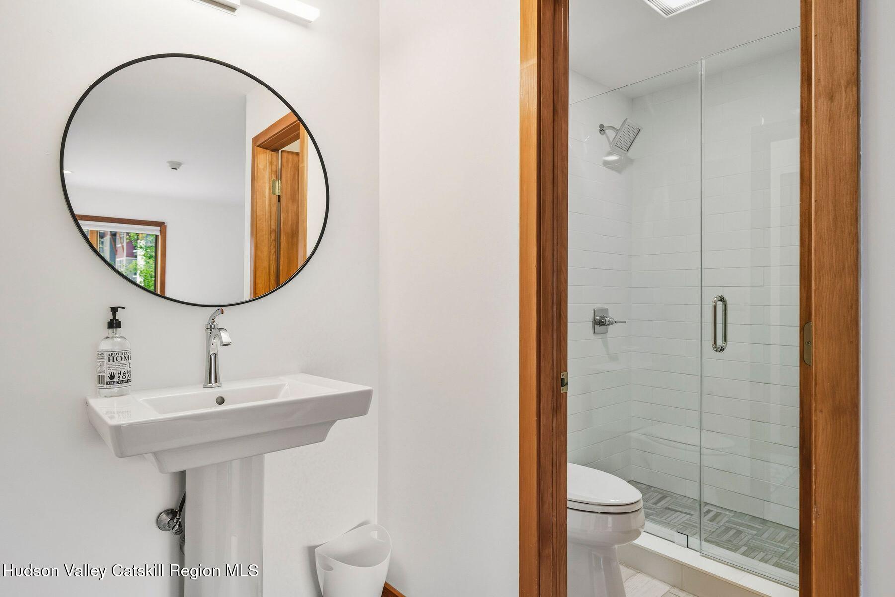 3 The Enclave Windham, NY 12496 - Photo 30 of 59 a bathroom with a sink and a mirror