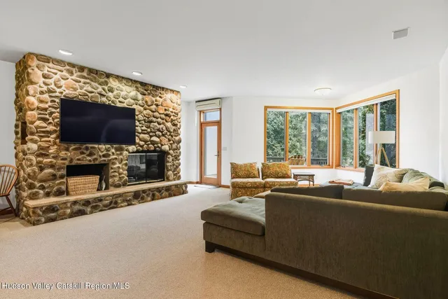 a living room with fireplace furniture and a flat screen tv